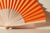 Handfächer Carla in der Farbe Orange im Angebot bei Hitzewelle dem Online Fächerstore